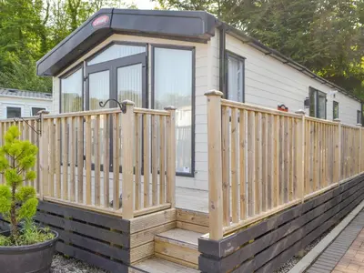 a small house with a wooden porch and a deck at Tranquil Lodge - Uk35277 in Brigham