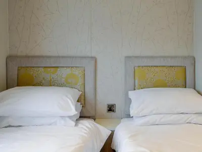 two beds sitting next to each other in a bedroom at Tranquil Lodge - Uk35277 in Brigham