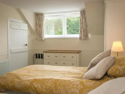 a bedroom with a bed with a window and a dresser at Uk35716 - North Cottage in Teviothead
