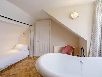 a bedroom with two beds and a white bedvisor at Erriff At Caelaverock in Glencaple