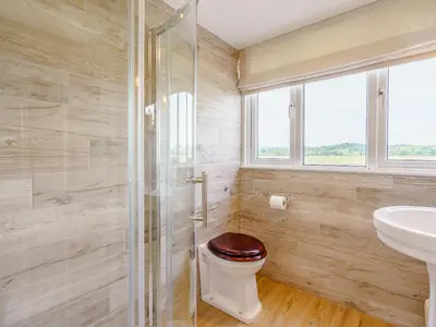 a bathroom with a toilet and a sink at Erriff At Caelaverock in Glencaple