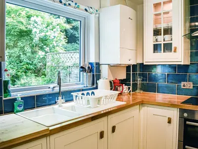 a kitchen with a sink and a window at Jane Eyre Cottage in Keswick