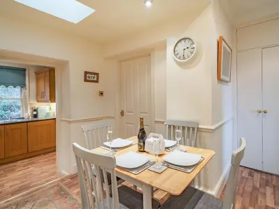 a kitchen and dining room with a wooden table and chairs at Mell Fell in Watermillock