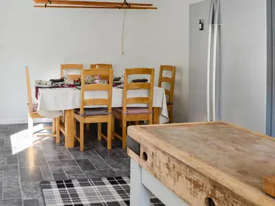 a dining room with a table and chairs at Oor Wee Hoose in Whithorn