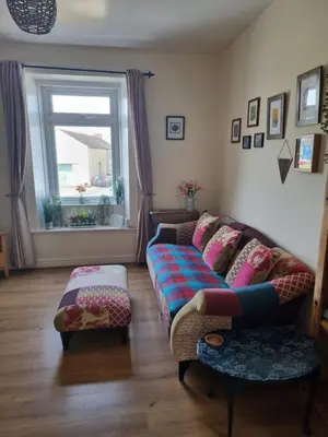 a living room with a couch and a window at West View Cottage in Seaside Village of Allonby Cumbria in Allonby