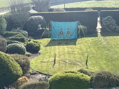 a blue tent in the middle of a yard at Galloway Farmstay Claunch in Newton Stewart