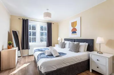a bedroom with a bed and a window at The Orchard - Donnini Apartments in Ayr