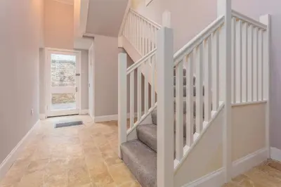 an empty hallway with stairs in a home at The Orchard - Donnini Apartments in Ayr