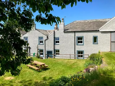 a house with a picnic bench in front of it at Penny End, Mosser - Western Lakes and great walks in Cockermouth
