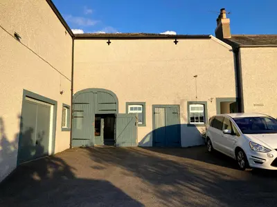 a white car parked in front of a building at Penny End, Mosser - Western Lakes and great walks in Cockermouth