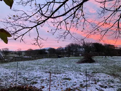 a field covered in snow with a sunset at Penny End, Mosser - Western Lakes and great walks in Cockermouth