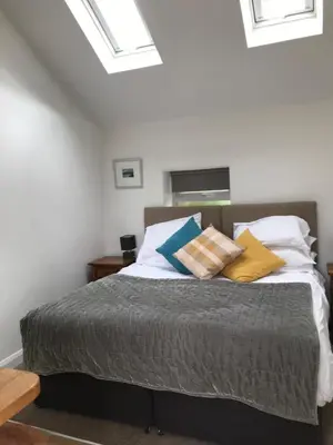 a bedroom with a bed with pillows on it at The Nook at Claremont House CA12 4LT in Keswick