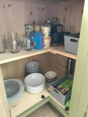 a shelf with plates and bowls and other items on it at The Nook at Claremont House CA12 4LT in Keswick