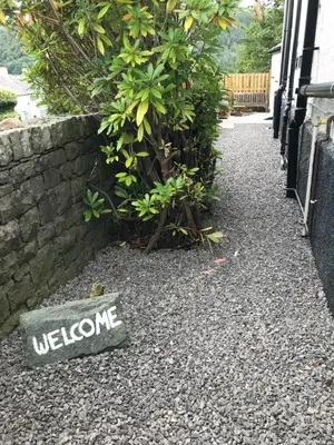 a welcome sign on the ground next to a wall at The Nook at Claremont House CA12 4LT in Keswick