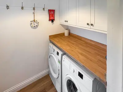 a laundry room with a washer and dryer at Thistle Cottage in Portpatrick