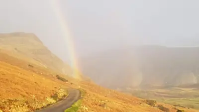 a rainbow on the side of a road at Scafell Cottage on The Big 