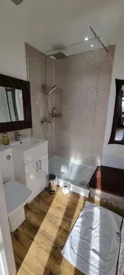 a bathroom with a shower and a sink and a tub at Scafell Cottage on The Big 