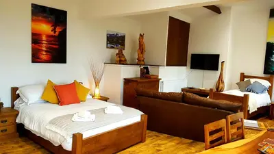 a room with a bed and a couch in it at Scafell Cottage on The Big 