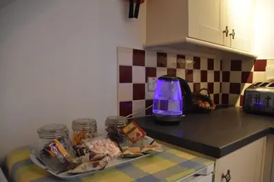 a kitchen counter with a plate of food and a toaster at Rainors farm cottage in Gosforth