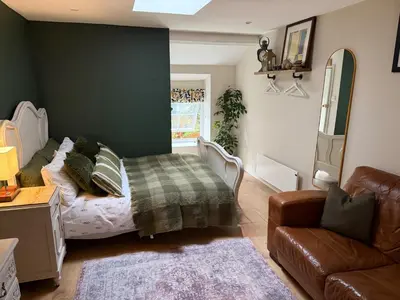 a bedroom with a bed and a couch at 1-Bed studio Apartment nr Cockermouth in Cockermouth