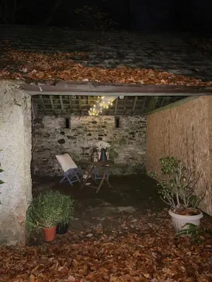 a room with a table and a chair in a brick wall at 1-Bed studio Apartment nr Cockermouth in Cockermouth