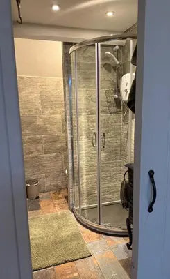 a shower with a glass door in a bathroom at 1-Bed studio Apartment nr Cockermouth in Cockermouth