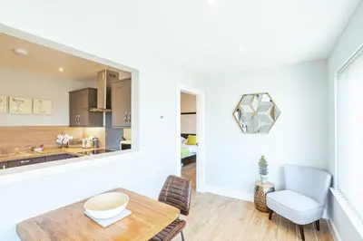 a kitchen and dining room with a table and chairs at Kestrel Lodge 7 with Hot Tub in Newton Stewart