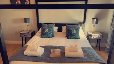 a bedroom with a large bed with two night stands at Kestrel Lodge 7 with Hot Tub in Newton Stewart
