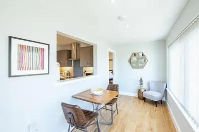 a kitchen and dining room with a table and chairs at Kestrel Lodge 7 with Hot Tub in Newton Stewart