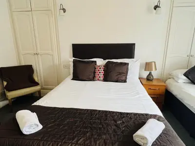 a bedroom with a large bed with two pillows at The Roadhouse Hotel in Carlisle