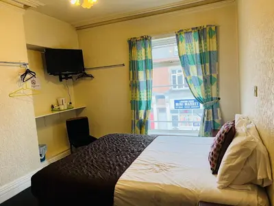 a bedroom with a bed and a window at The Roadhouse Hotel in Carlisle