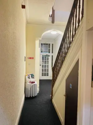 a hallway with a staircase and a table in a room at The Roadhouse Hotel in Carlisle