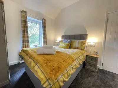a bedroom with a large bed and a window at Fairbank in Keswick