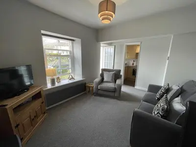 a living room with a couch and a television at Gretaside in Keswick