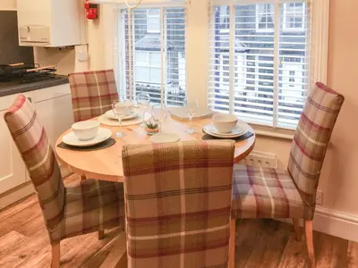 a dining room with a wooden table and chairs at Upton Down in Keswick