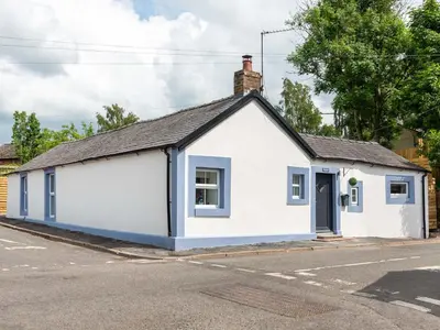 a white and blue building on the side of a street at Highgate in Kirklinton