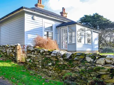 a small house behind a stone wall at Clarksburn Blue in Monreith
