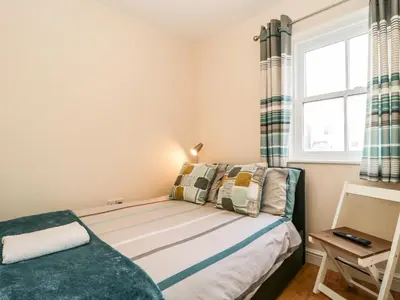 a small bedroom with a bed and a window at Fox's Retreat in Keswick