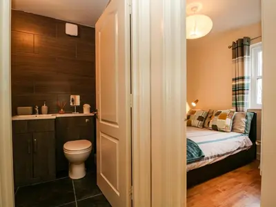 a small bathroom with a bed and a toilet at Fox's Retreat in Keswick