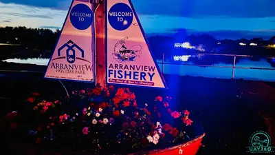 a bunch of flowers in a bucket with a sign at Arranview Lochside Pods & Lodges all with private Hot-tubs in Fenwick
