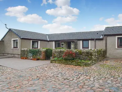 a house with a stone driveway in front of it at Scalelands Cottage in Frizington