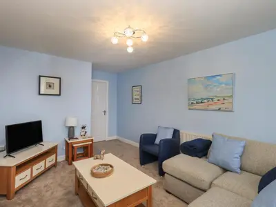 a living room with a couch and a tv at Solway View in Wigton