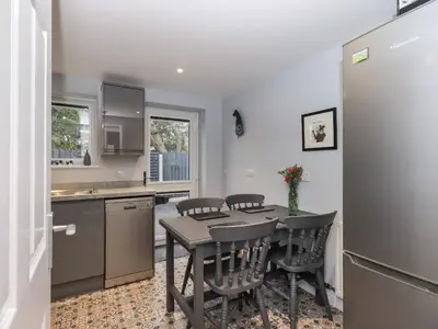 a kitchen with a table and chairs in a room at Solway View in Wigton
