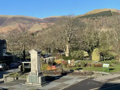 a monument in a cemetery with mountains in the background at Skiddaw View in Keswick