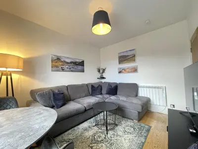 a living room with a couch and a table at Skiddaw View in Keswick
