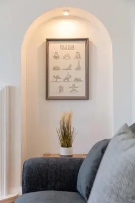 a room with a couch and a picture on the wall at Wellington View - Donnini Apartments in Ayr