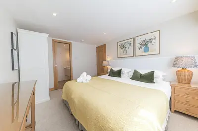 a bedroom with a large bed and a television at Cherry Garth HOT TUB HIRE AVAILABLE in Keswick