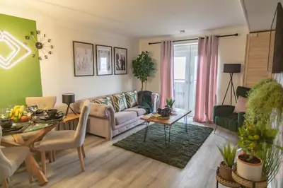 a living room with a couch and a table at The Marine - Balcony - Beach View - Coorie Doon Stays in Ayr