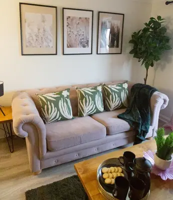 a living room with a couch and a table at The Marine - Balcony - Beach View - Coorie Doon Stays in Ayr