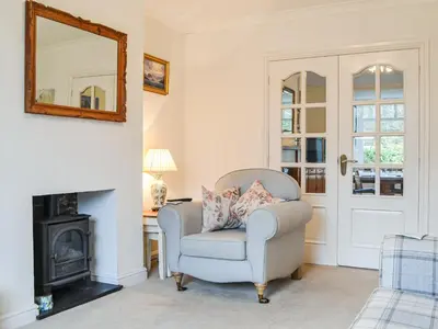 a living room with a chair and a mirror at Parkfield in Keswick